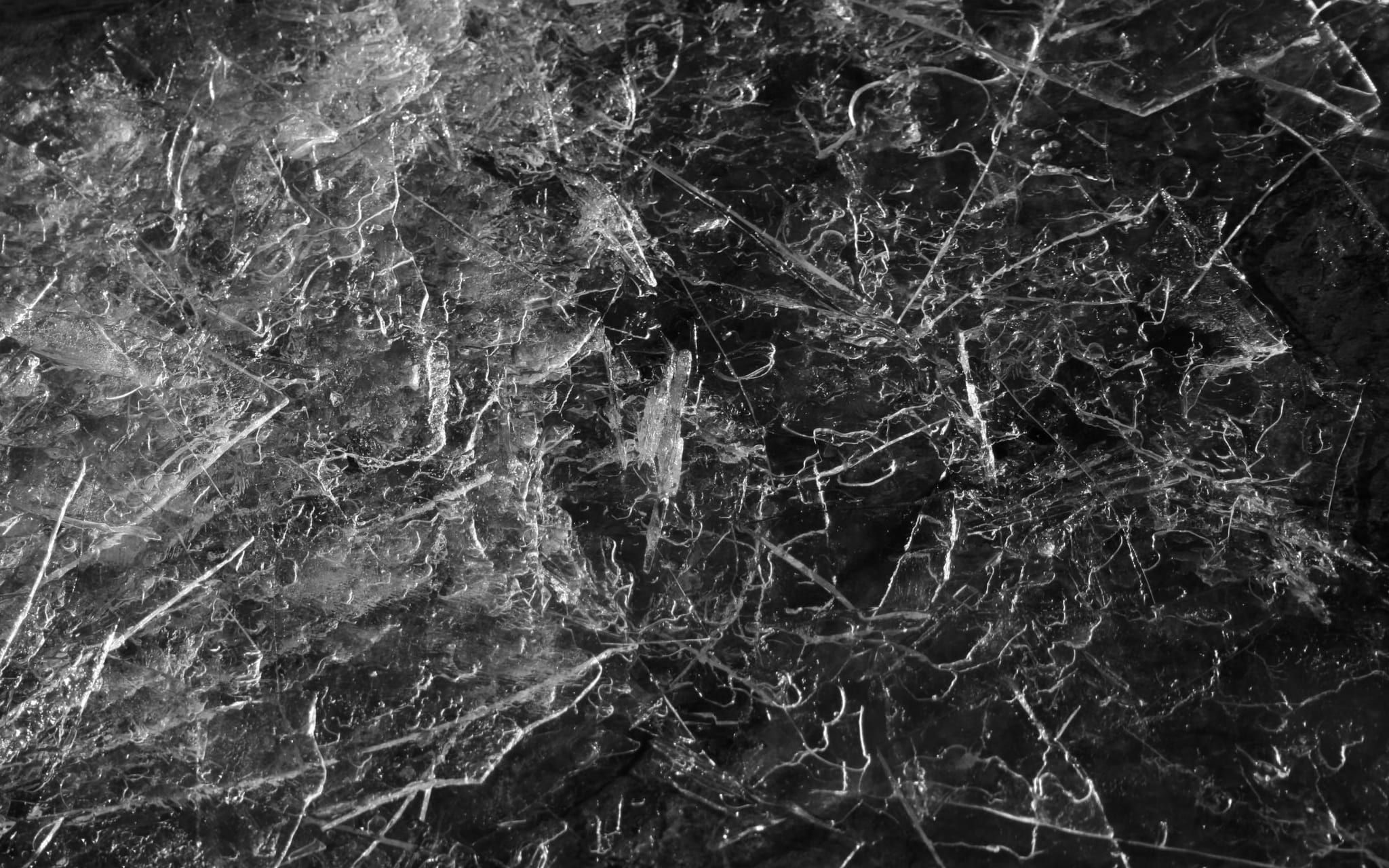 A hard glassy surface shot through with fine fracture lines