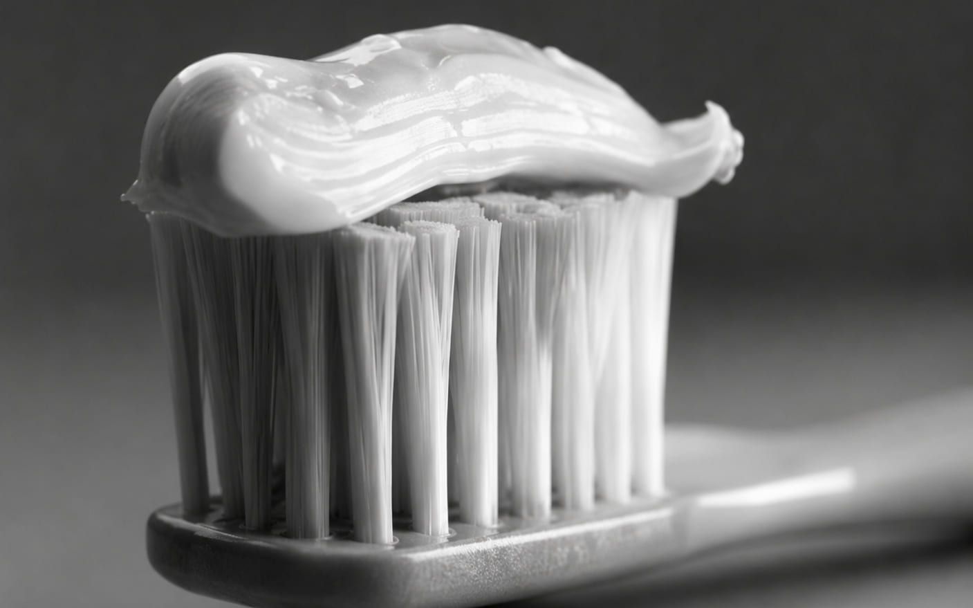 A ribbon of toothpaste on the bristles of a toothbrush