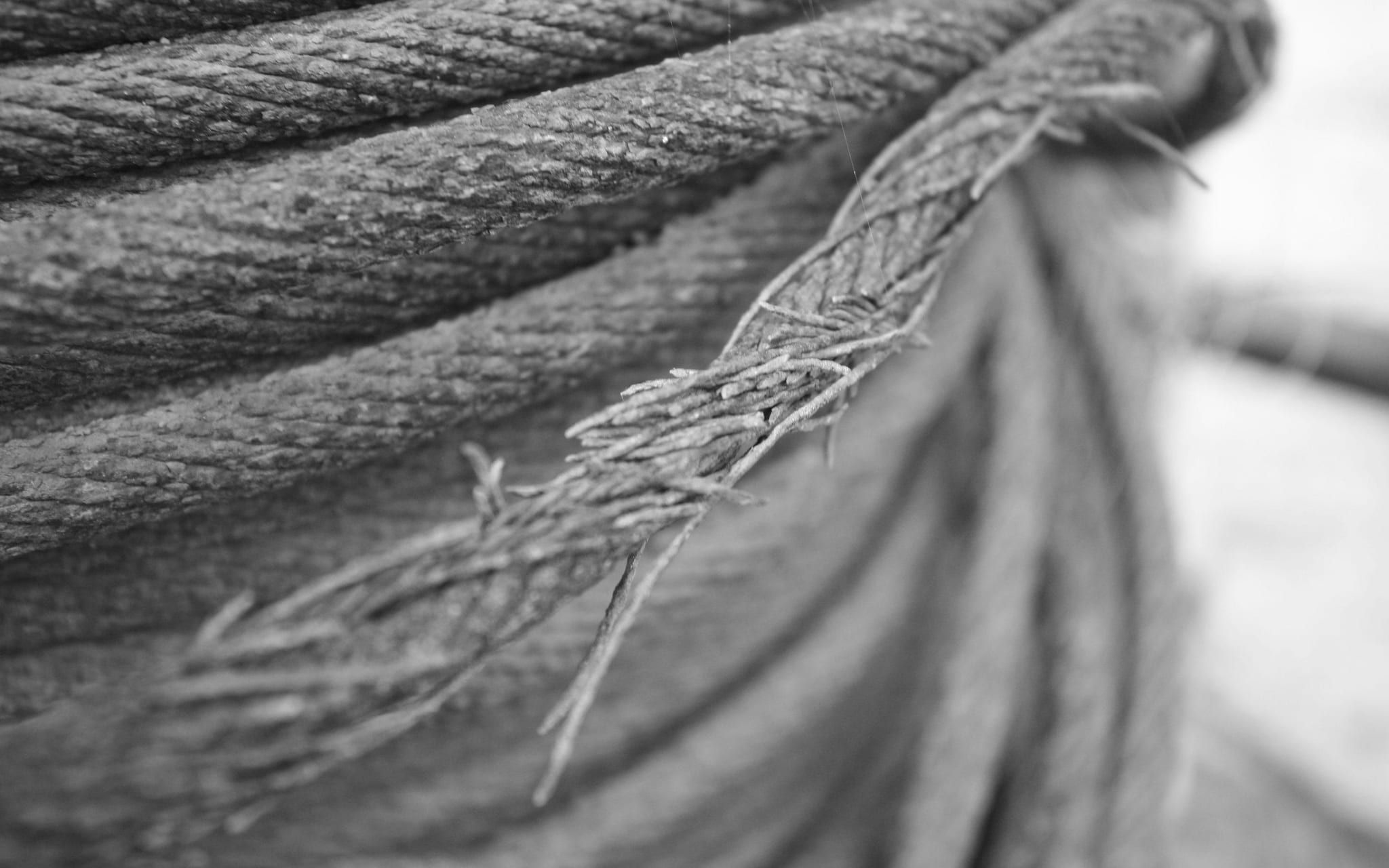 Close-up of a steel cable fraying apart under load